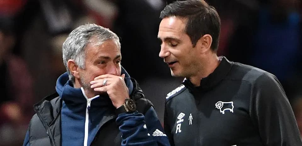 Trainers conversing on the sidelines during match