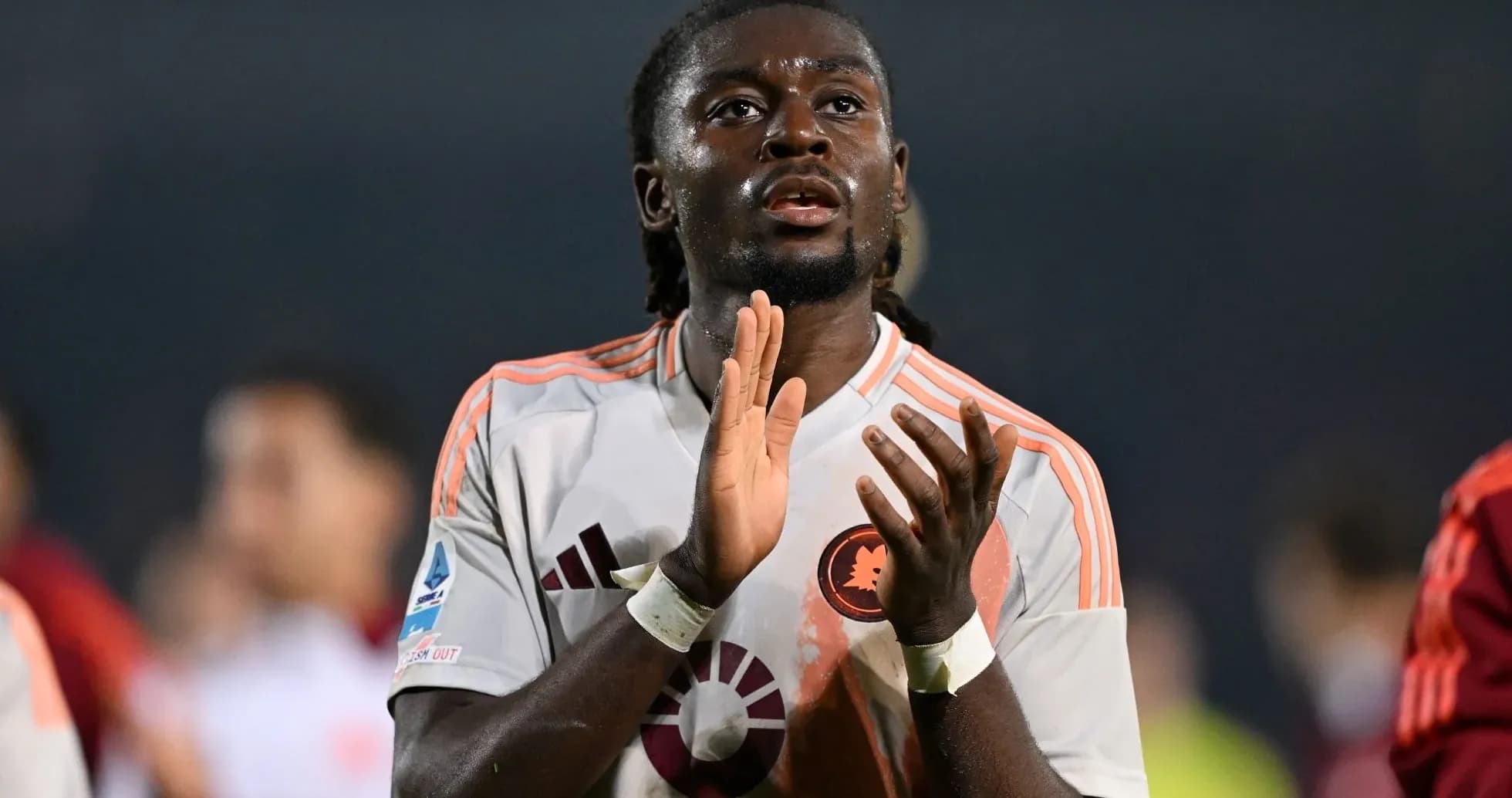 Futbolchi ochqoq bilan qo'llarini qarsillatmoqda