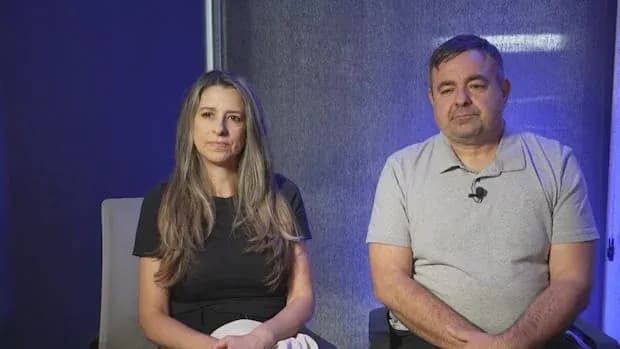 Two people sitting side by side in studio