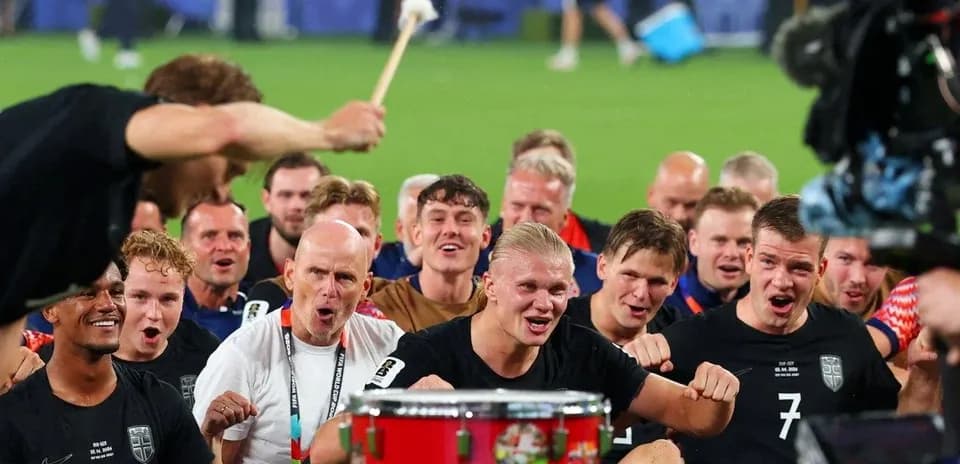 Team celebrating with a drum after match victory