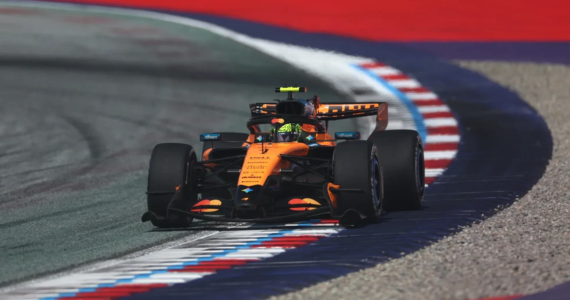 Formula 1 car navigating a track corner