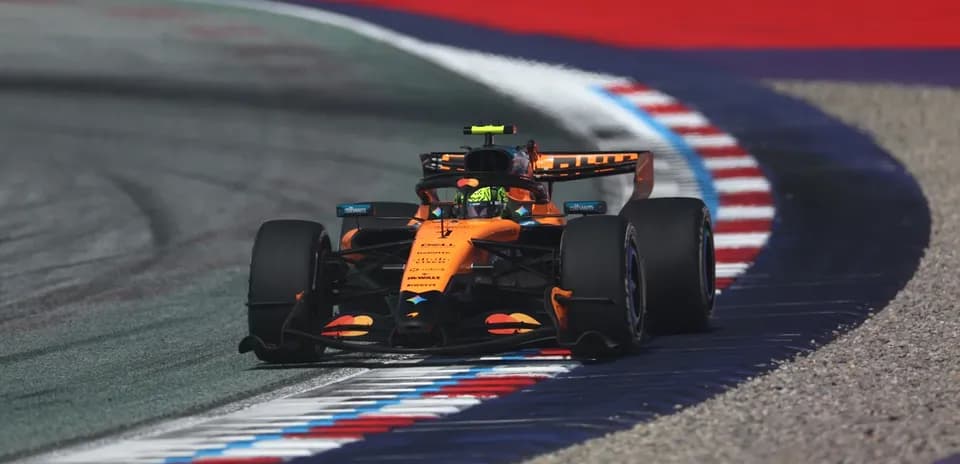 Formula 1 car navigating a track corner