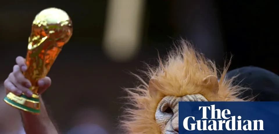 Fan in lion costume holding World Cup trophy