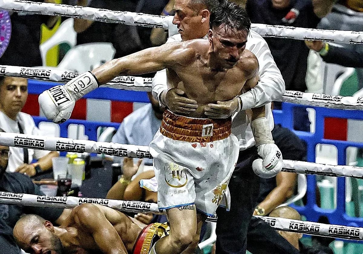Boxer being helped after a knockout in the ring