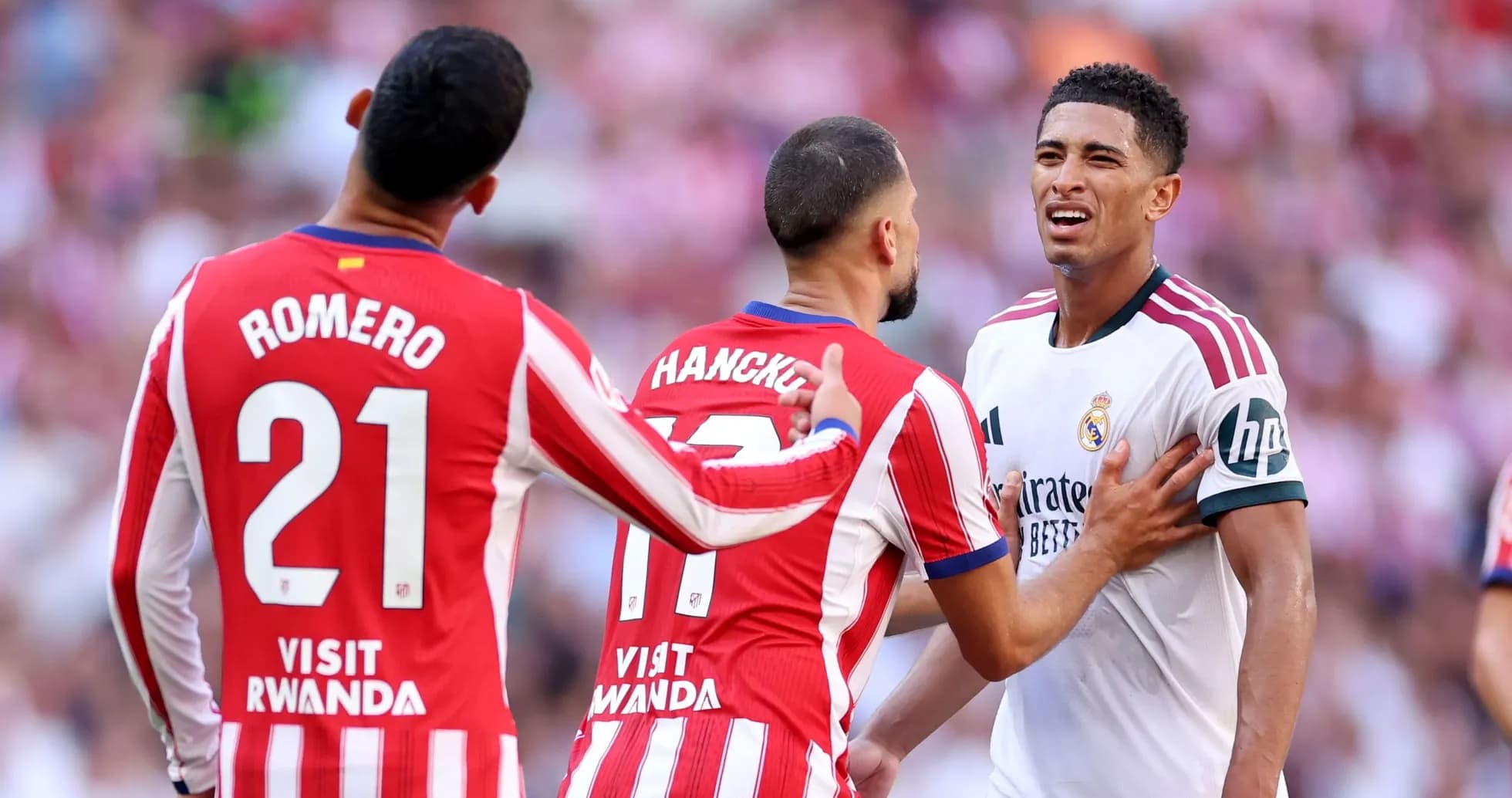Atletico Madrid players confronting Real Madrid opponent