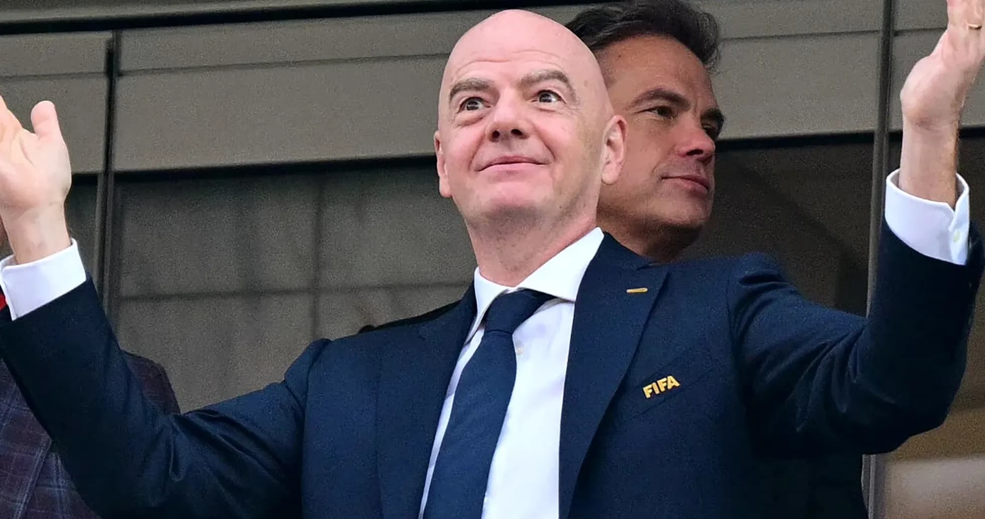 FIFA official gesturing from VIP box at event