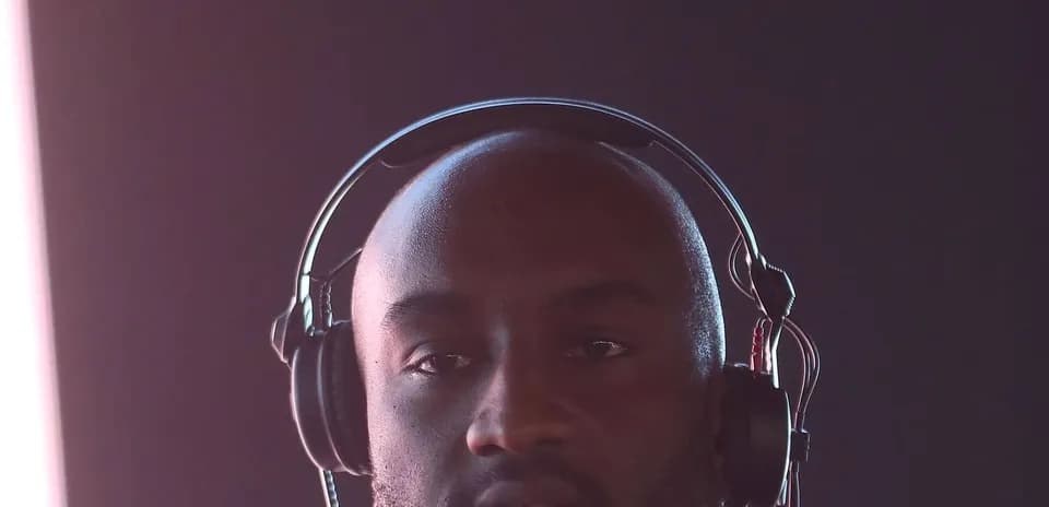 Man wearing headphones against a dark background