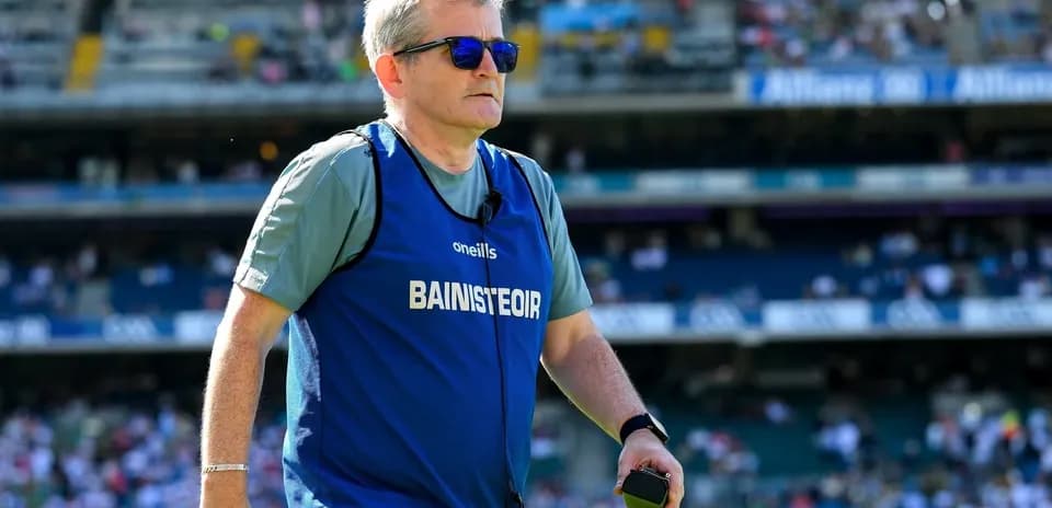 Coach wearing sunglasses on the field during match