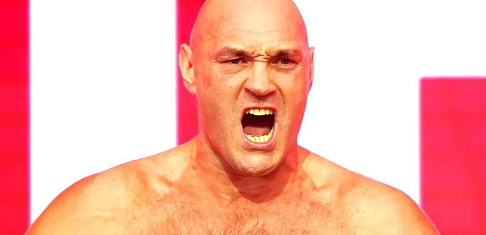 Bald man yelling with intense expression on stage