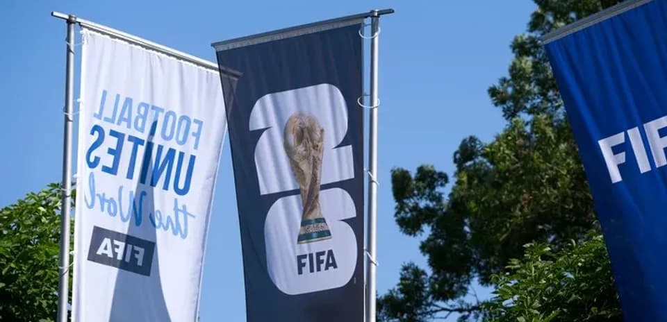 FIFA World Cup trophy on display with banners