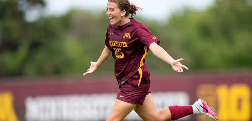 Futbolchi Minnesota formasida g'ildirab yugurmoqda