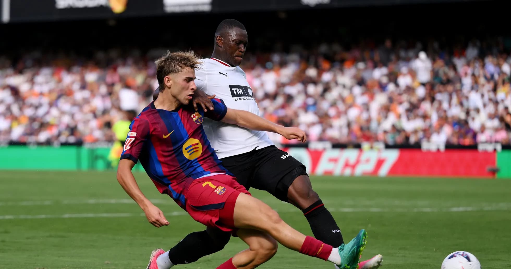 Barcelona player tackling opponent during match