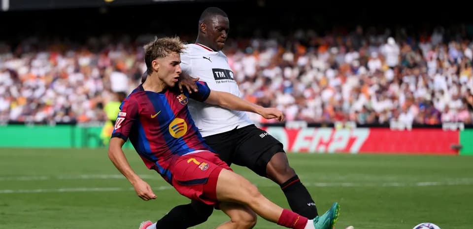 Barcelona player tackling opponent during match