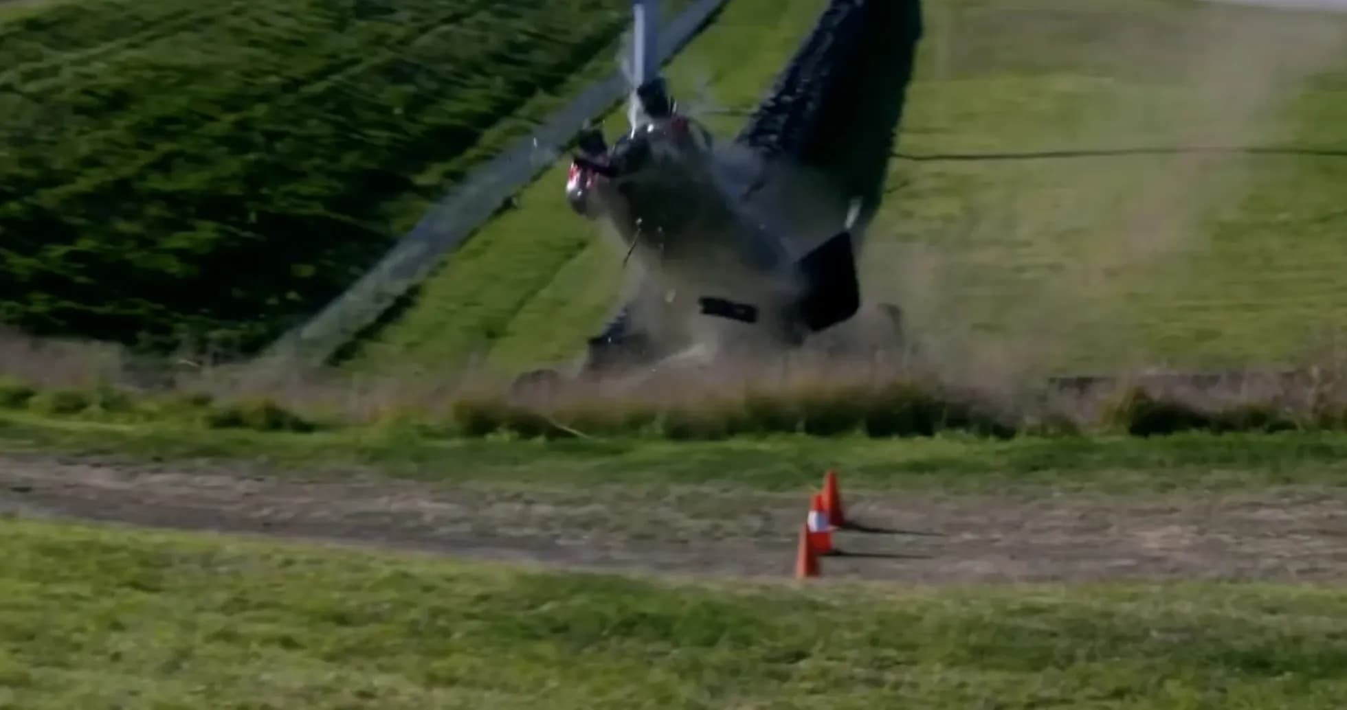 Helicopter crashing on grassy hillside