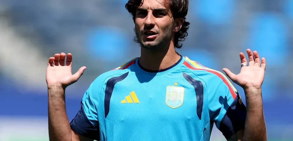 Futbolchi mashg'ulotda qo'llarini ko'tarib turibdi