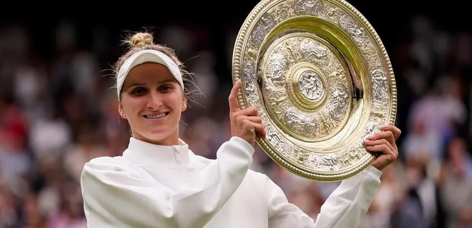Tennis player holding Wimbledon trophy after victory