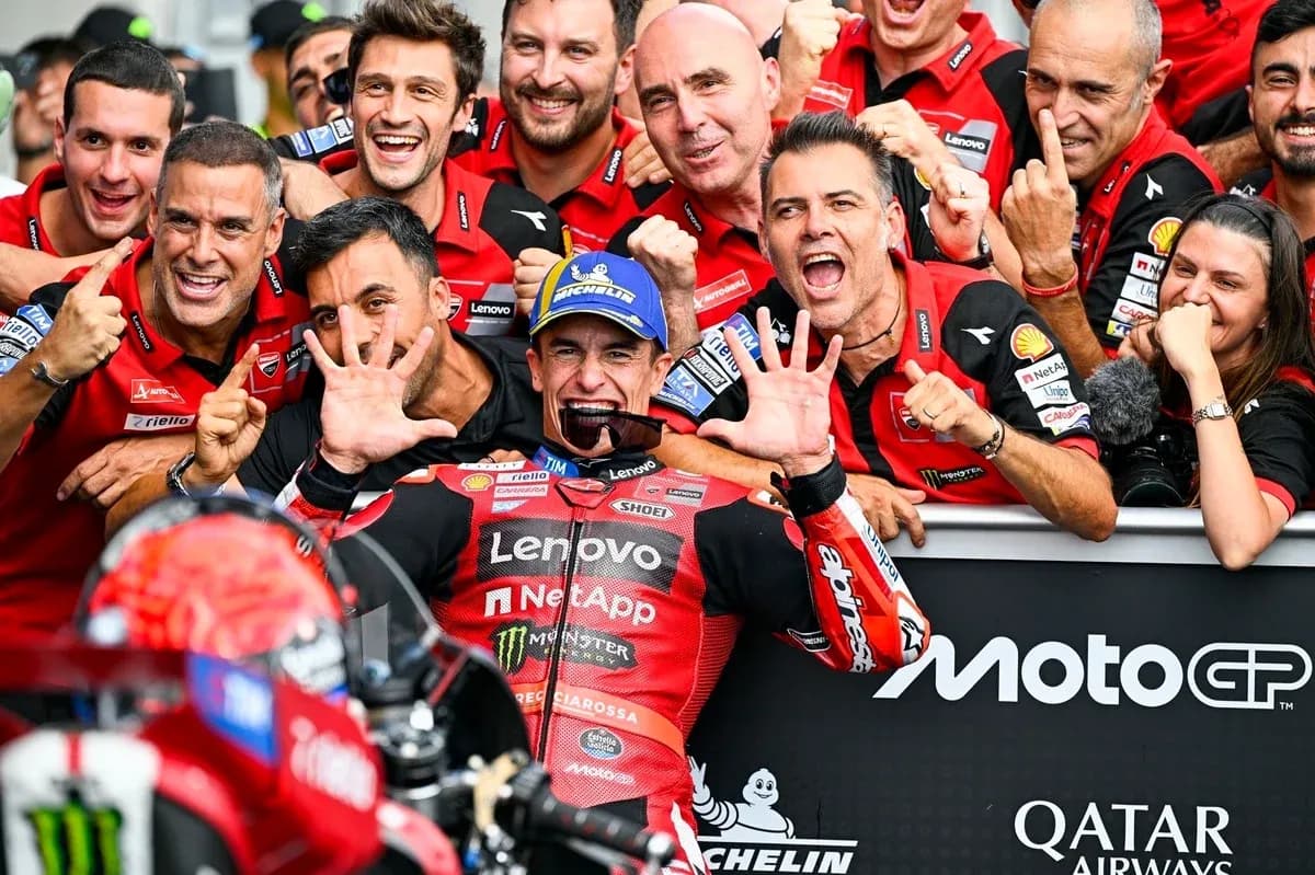 Ducati team celebrating victory with rider in center
