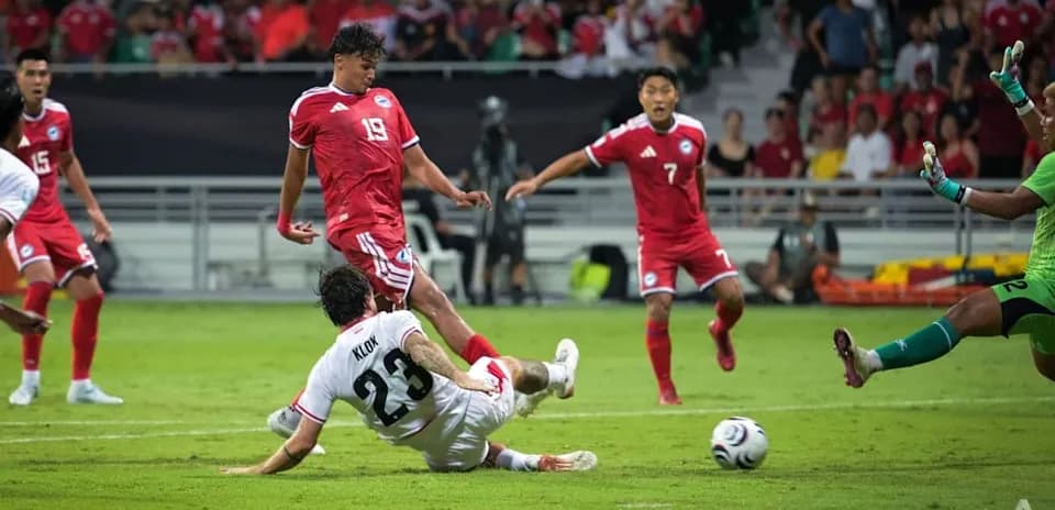 Player sliding tackle during football match action