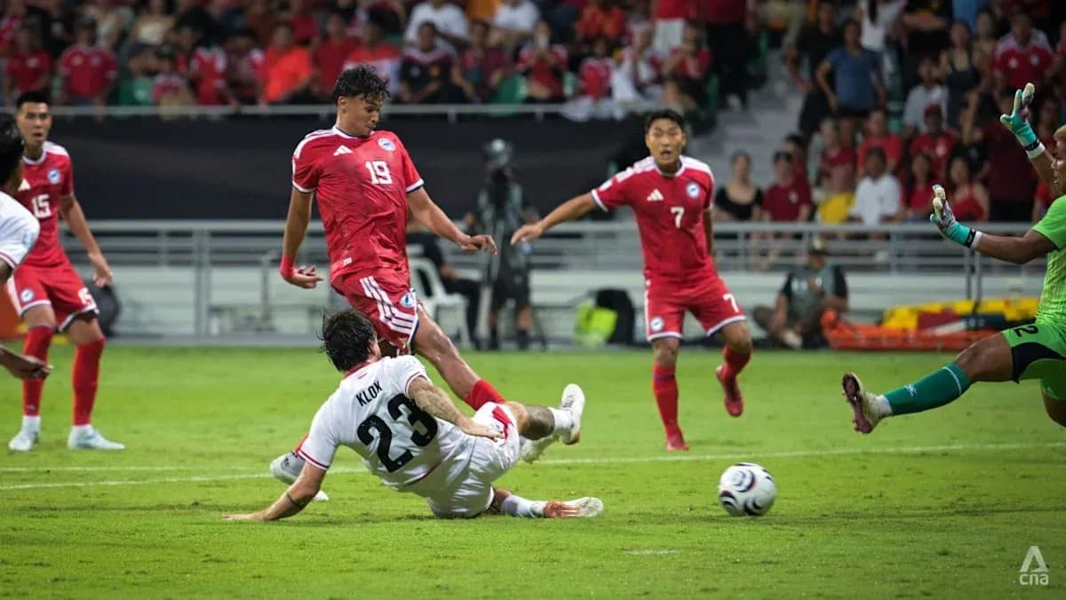 Player sliding tackle during football match action