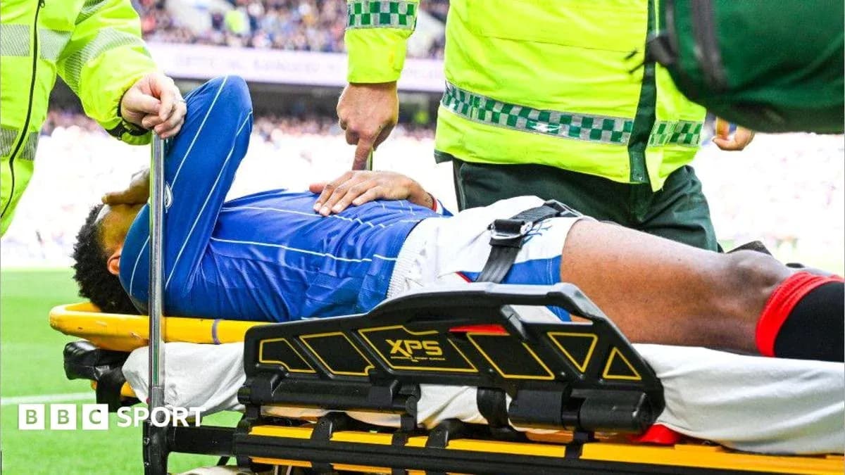 Player being assisted on stretcher by medical staff