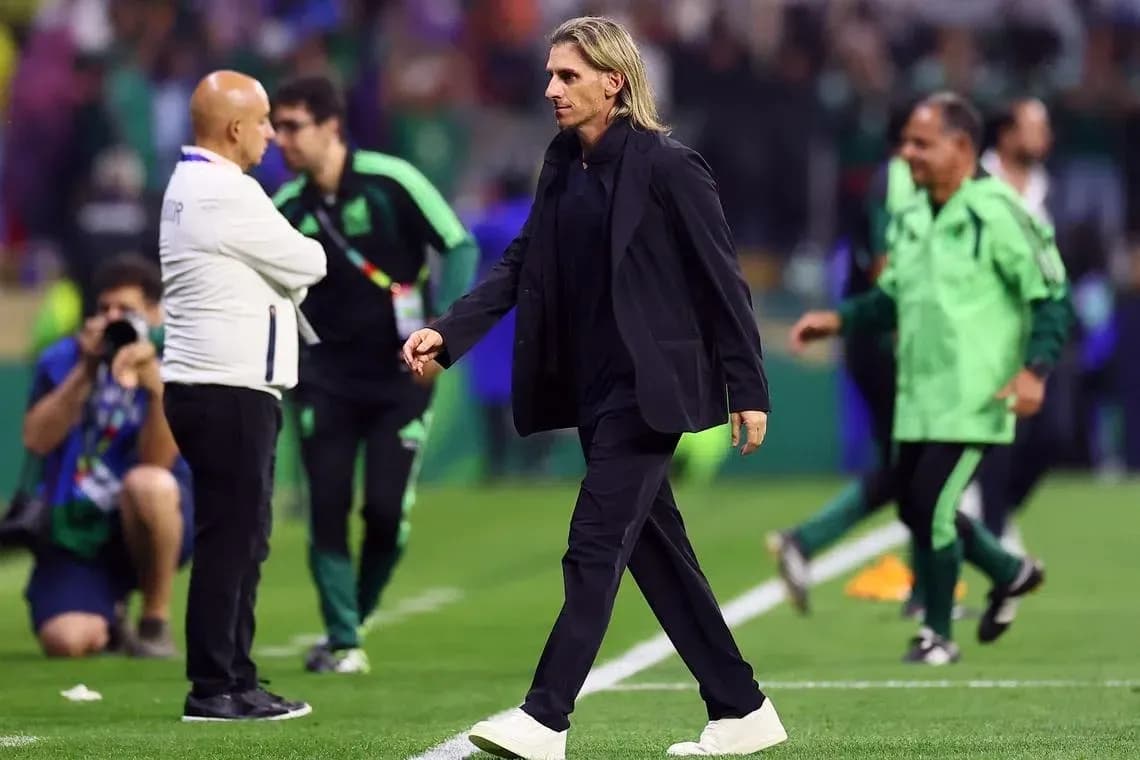 Coach walking past staff on the sidelines