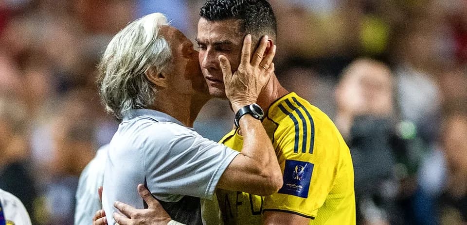 Coach embracing player during match moment