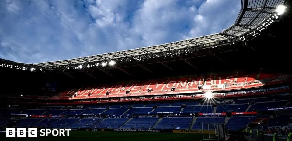 Empty stadium with bright lights and cloudy sky