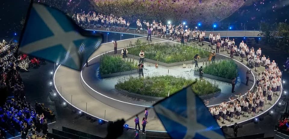 Performance stage with audience and Scottish flags