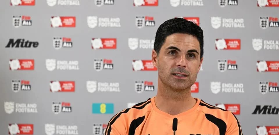 Mikel Arteta speaking at press conference table