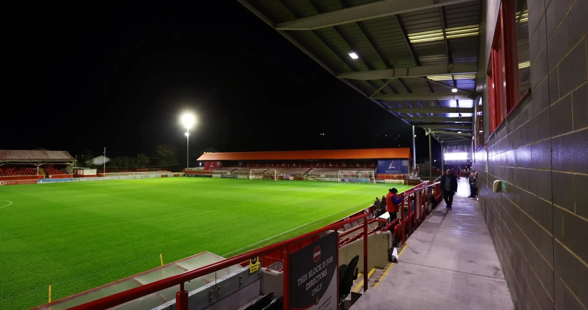 Stadium view with illuminated pitch at night