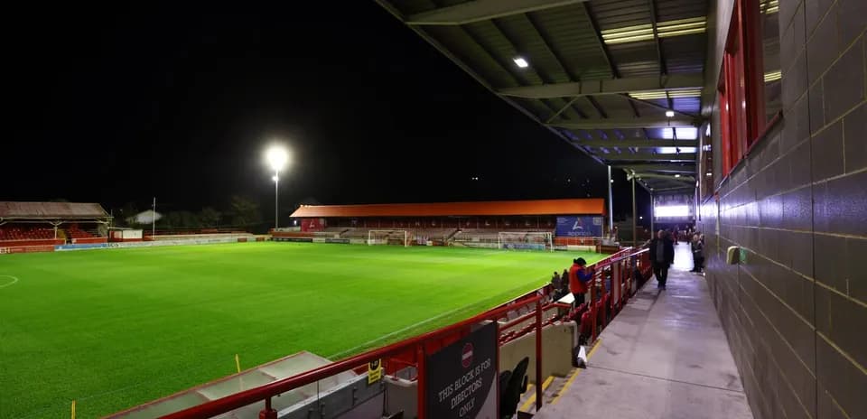Stadium view with illuminated pitch at night
