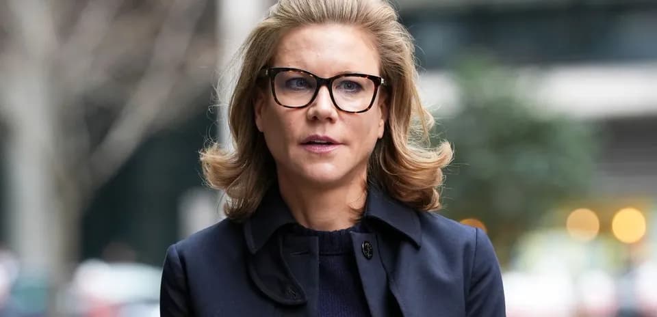 Woman in glasses walking outdoors in urban setting