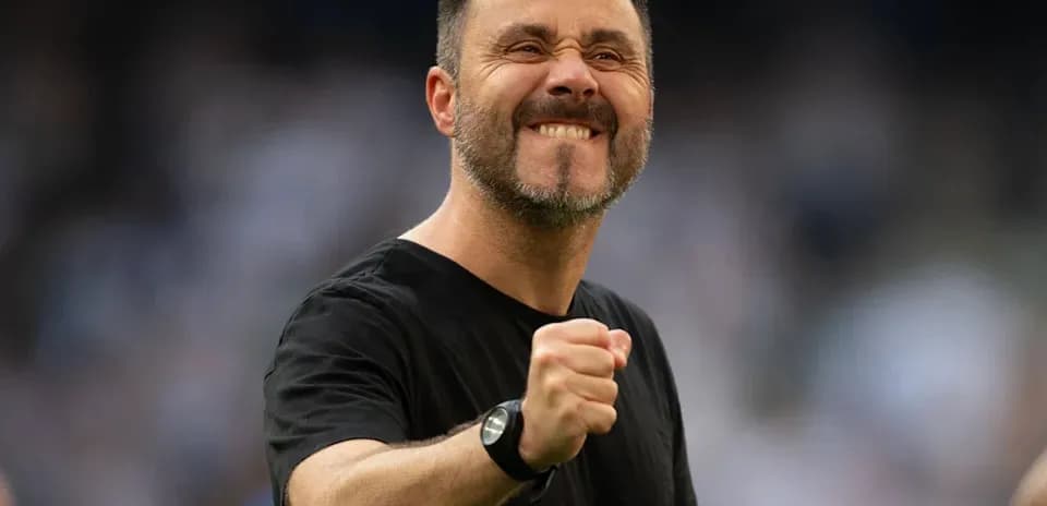 Coach celebrating with a fist pump on the field