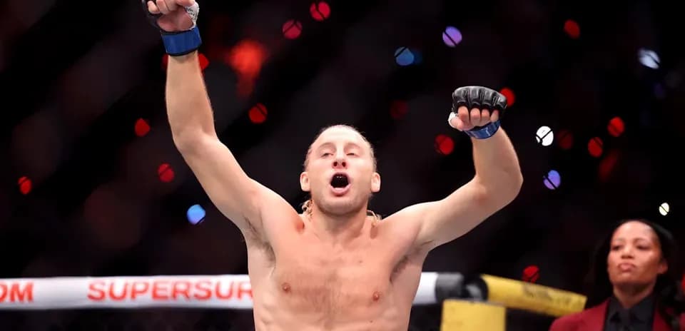 Fighter celebrating victory inside the octagon