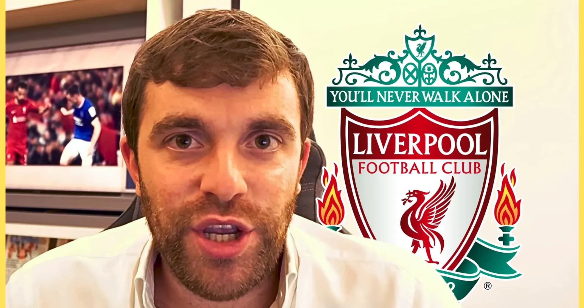 Journalist speaking with Liverpool FC logo in background