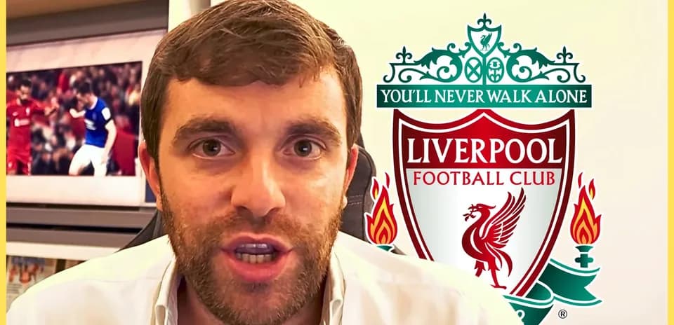 Journalist speaking with Liverpool FC logo in background
