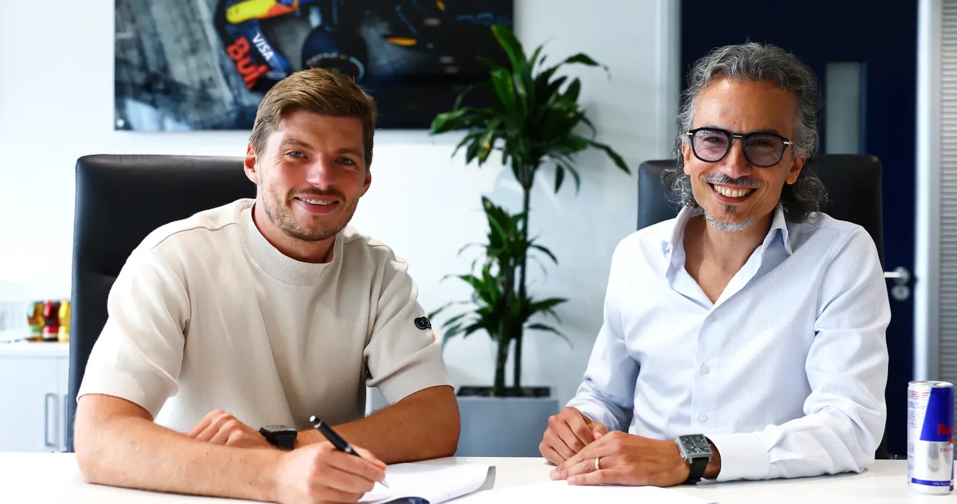 Formula 1 driver signing contract in office