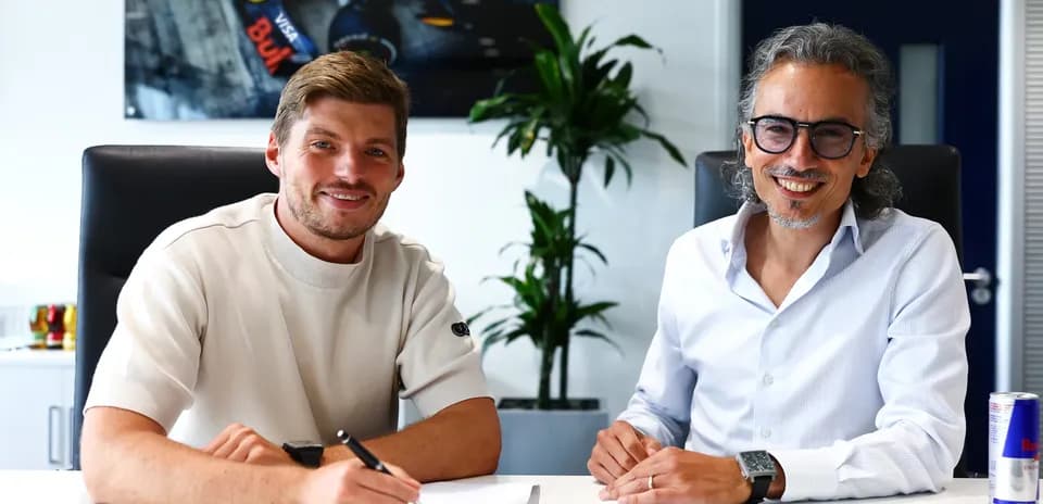 Formula 1 driver signing contract in office