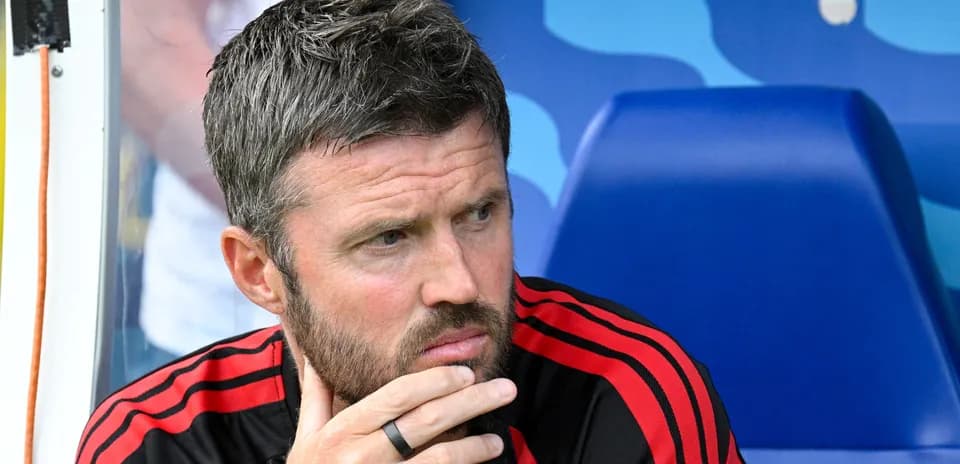 Coach sitting on bench during match contemplation