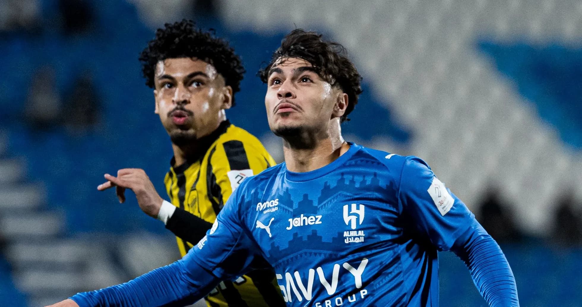Two players competing for the ball during match