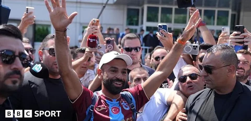 Football player greeting fans outside venue
