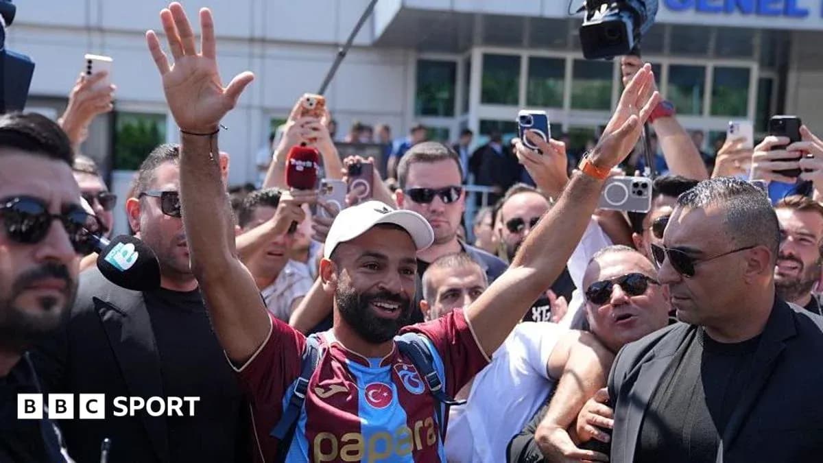 Football player greeting fans outside venue