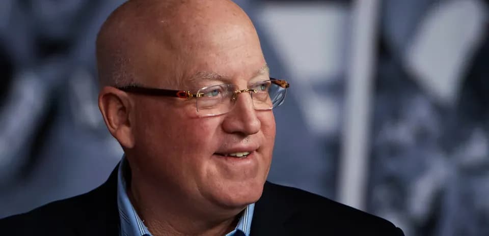 Man with glasses smiling during event