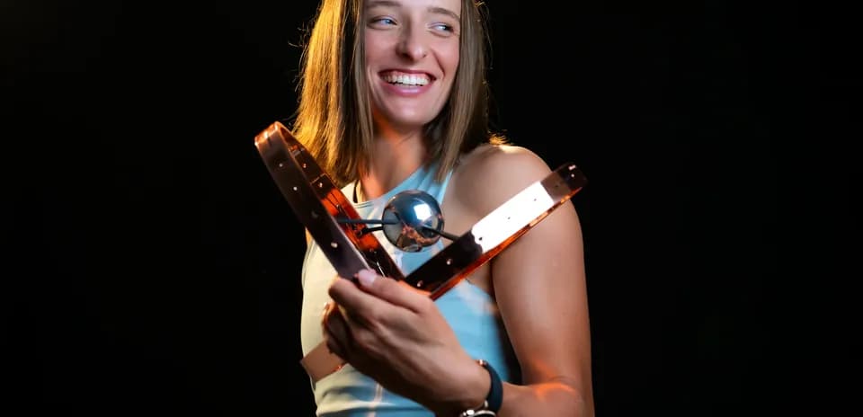 Athlete holding a trophy with a smile