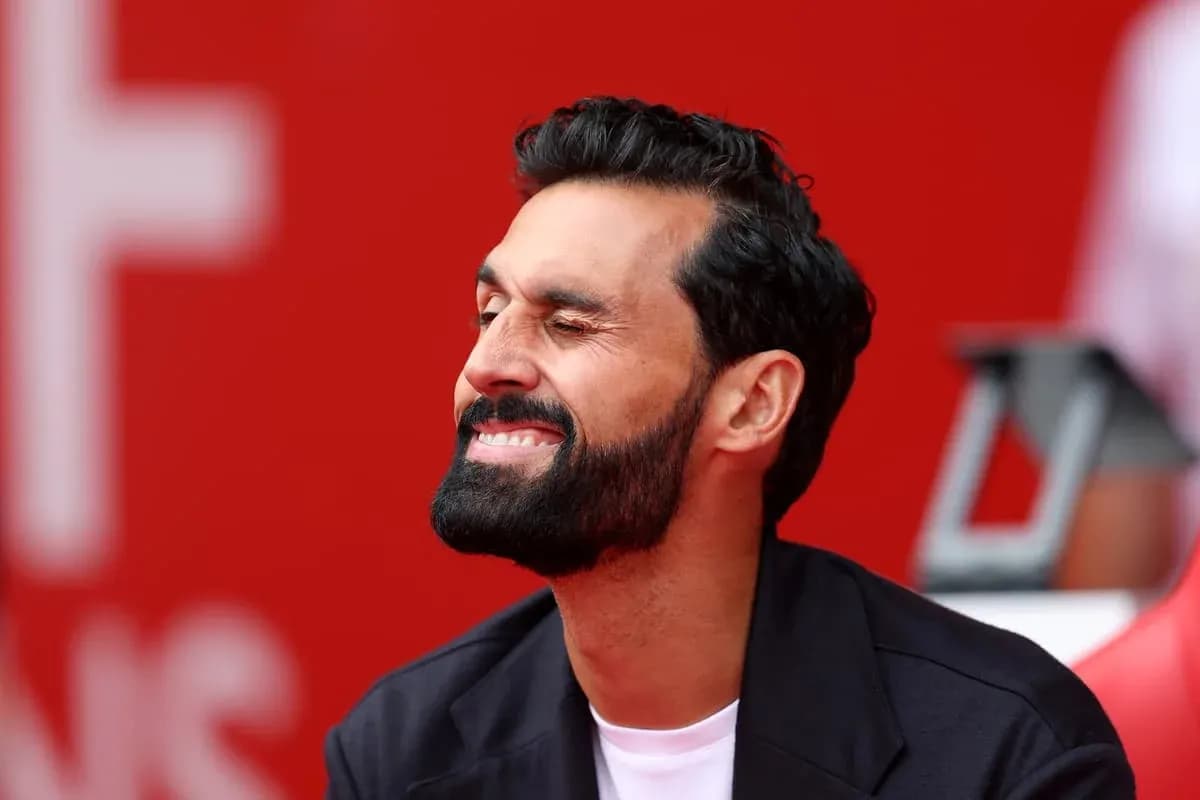 Man sitting with a smile against a red background