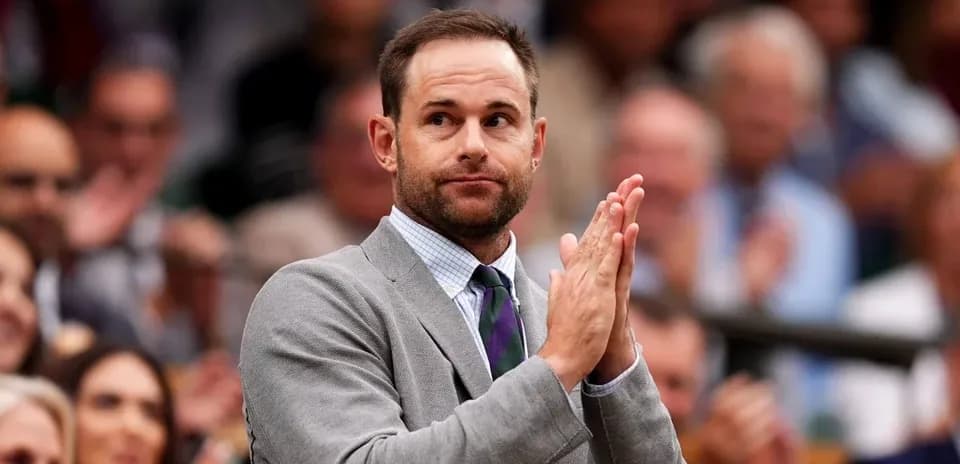 Man in suit applauding at a public event