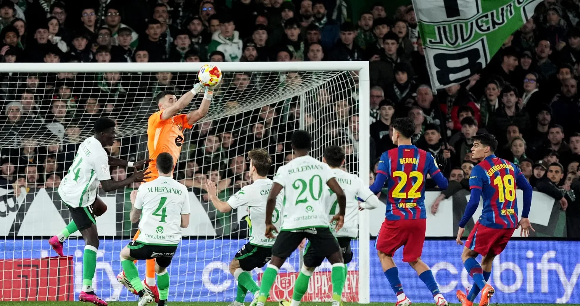Goalkeeper catching the ball during intense match action