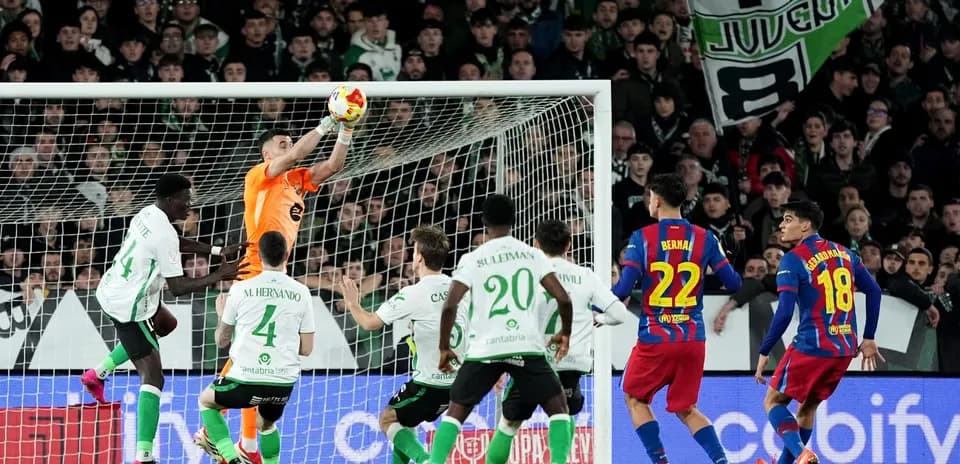 Goalkeeper catching the ball during intense match action