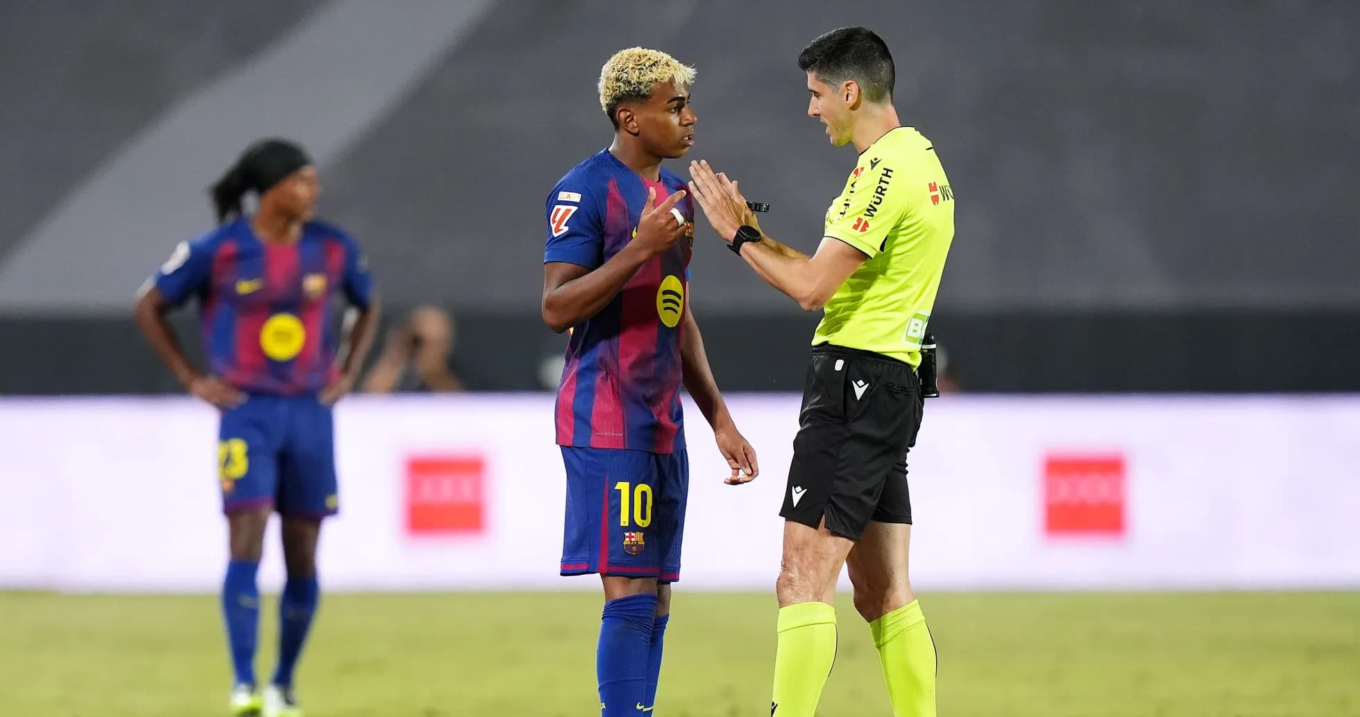 Barcelona player discussing with referee during match