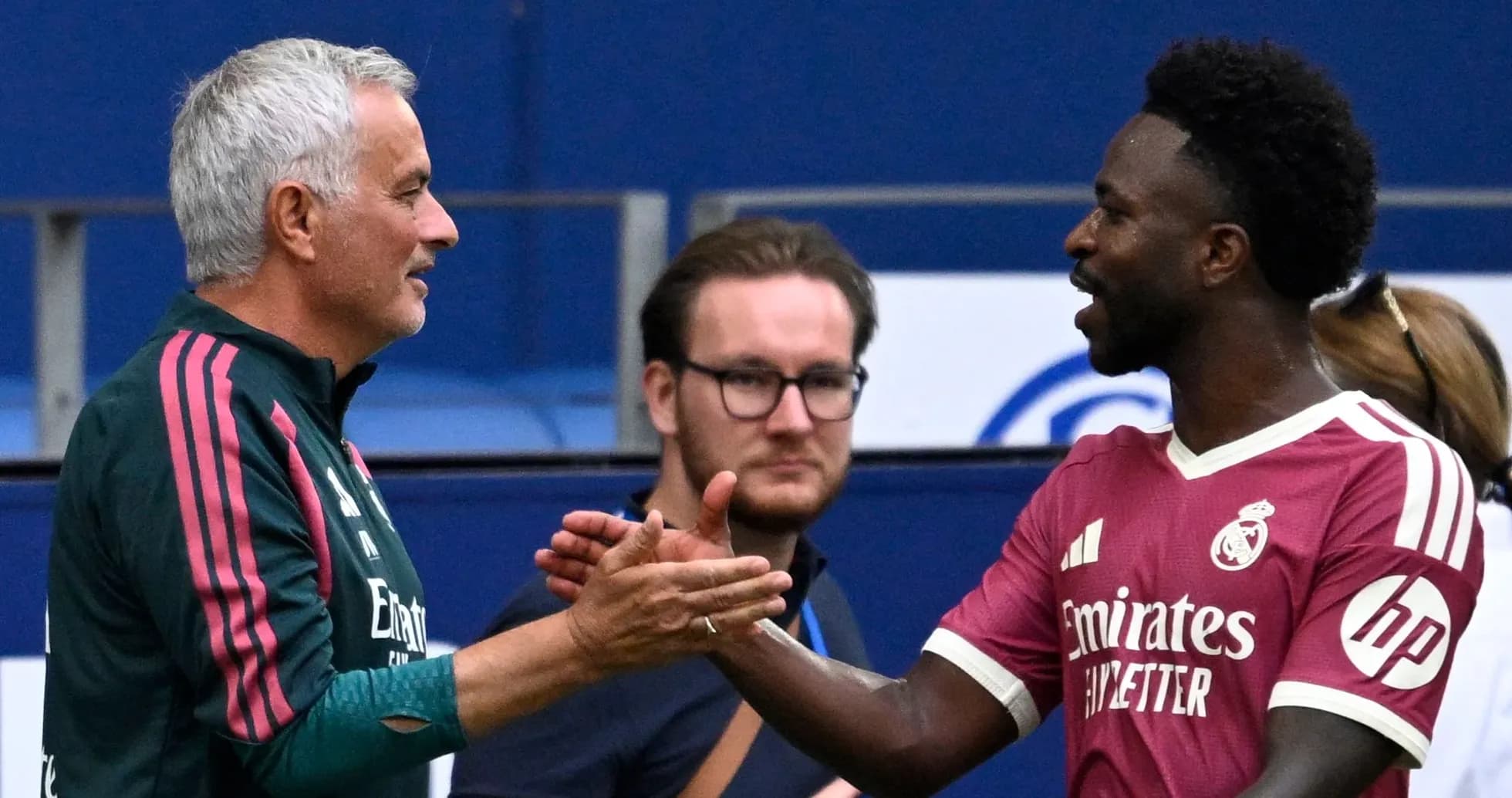 Trainers shaking hands during a match warm-up